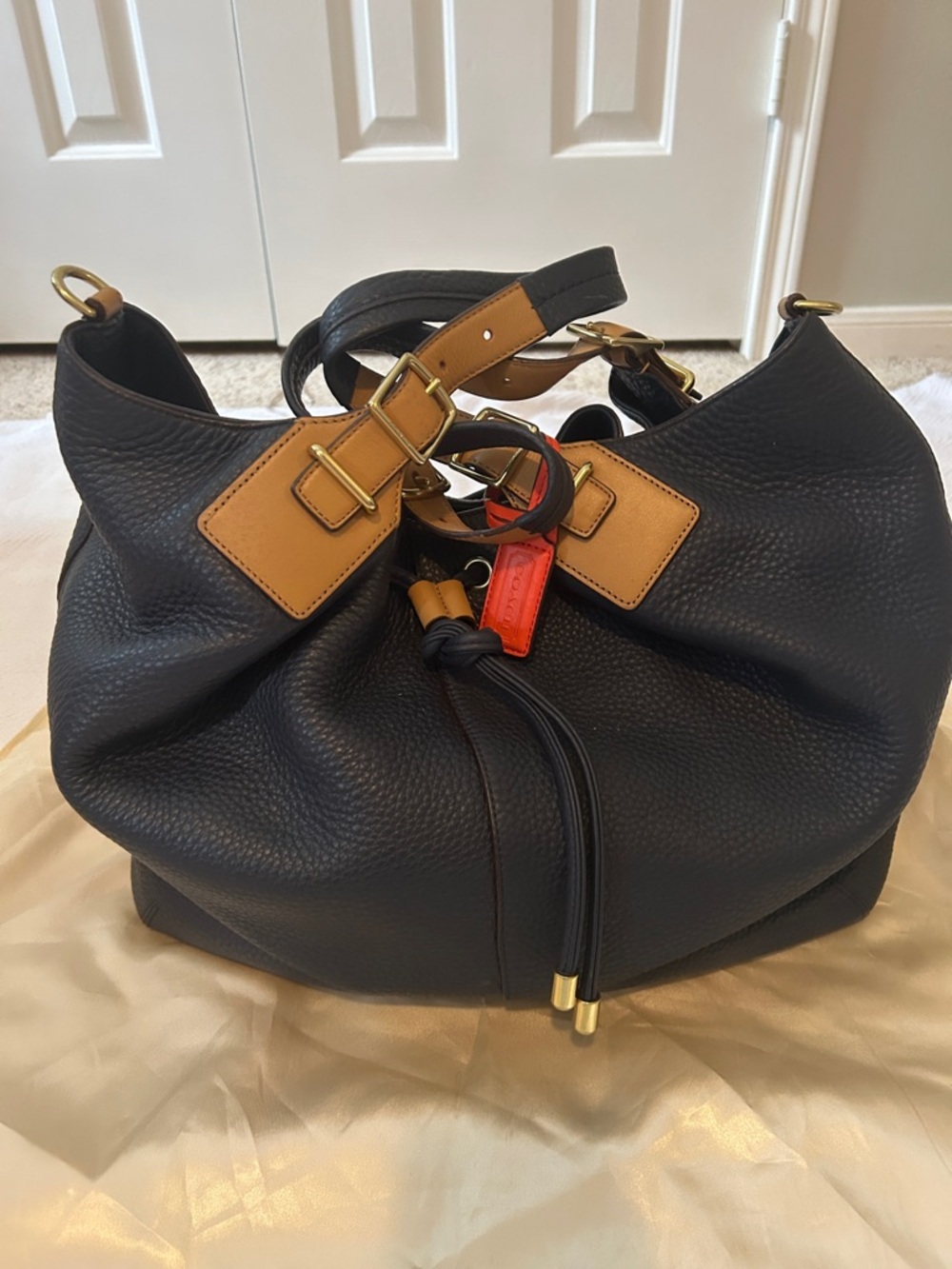Legacy Coach Navy Pebbled Leather Drawstring Tote with Tan Straps and Orange Tag